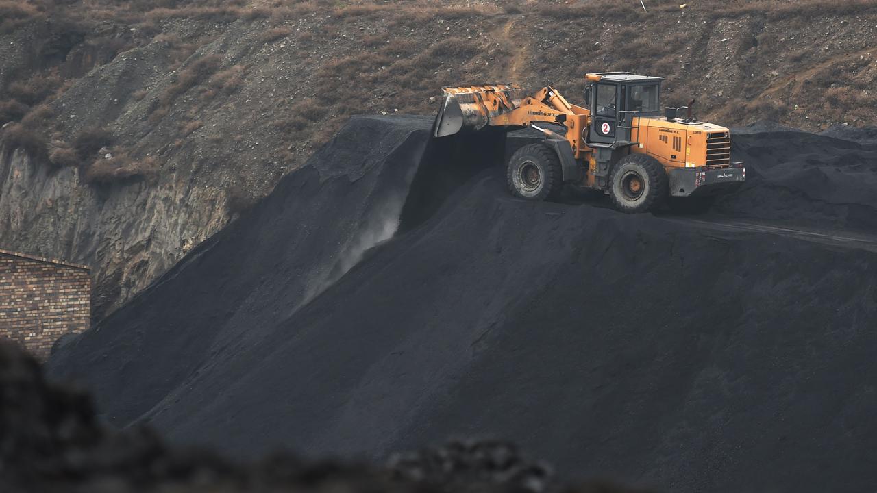 2015: A front-end loader drops coal near Datong in northern China's Shanxi province. (Photo by Greg Baker / AFP)