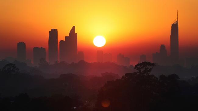 Smoke haze from bushfires descended on the Gold Coast this morning, blanketing the high rises and making for a spectacular sunrise. Picture: Glenn Hampson