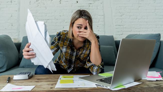 Portrait of desperate young woman feeling stressed checking online banking accounting home finances not able to pay off debts, mortgage, rent and expenses. In paying bills and financial problems.