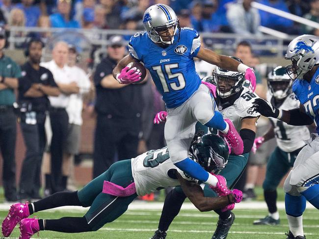 Wide receiver Golden Tate #15 of the Detroit Lions jumps over cornerback Ron Brooks.