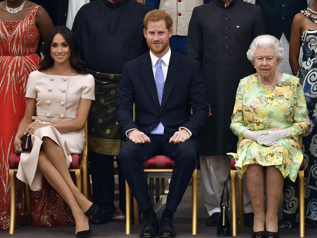 Meghan, Harry and the Queen at Buckingham Palace. Picture: AP