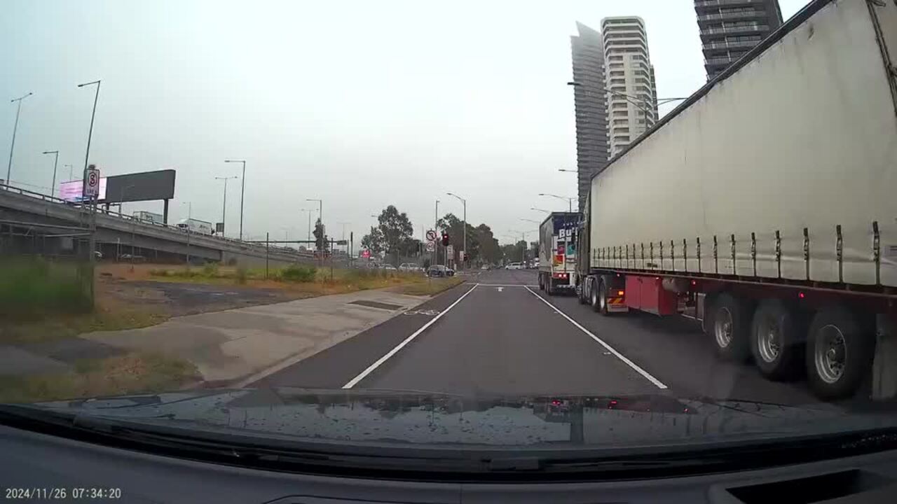 Dash cam captures moment cyclist is almost squashed by truck