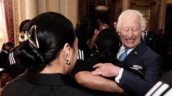 Britain's King Charles III is hugged by members of New Zealand's Black Ferns rugby union team, at Buckingham Palace in September. Picture: Aaron Chown/POOL/AFP