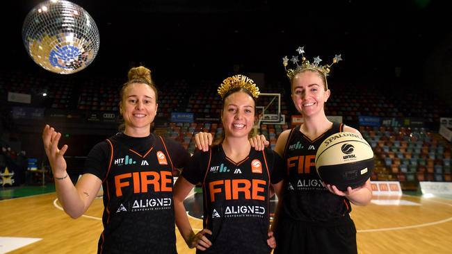 Townsville Fire players Lauren Mansfied, Abbey Ellis and Courtney Woods can't wait for the New Year's Eve clash with the Bendigo Spirit at the Townsville Entertainment Centre. Picture: Evan Morgan