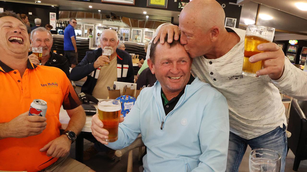 Cam Smith’s father Des Smith celebrates his son winning the British Open with friends at the Wantima Golf Club.