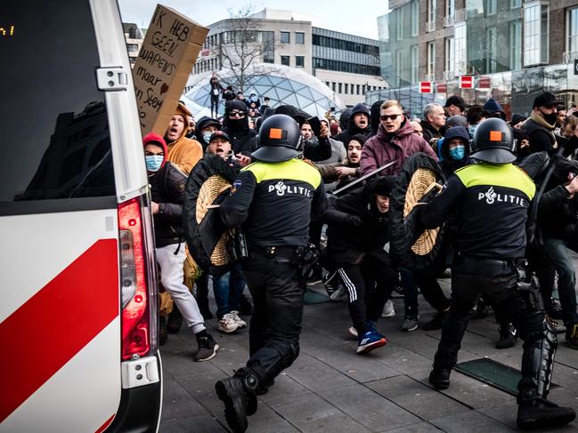 Protesters clash against Dutch anti-riot police officers during a demonstration against coronavirus restrictions in Eindhoven, the Netherlands. Picture: AFP / Netherlands OUT