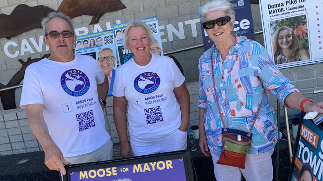 Kevin and Kelly Plummer and Marie Moran greet voters at a Coffs Harbour City Council election booth on Saturday.