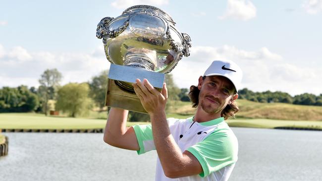 British player Tommy Fleetwood poses with the trophy after winning the HNA Open de France golf tournament.