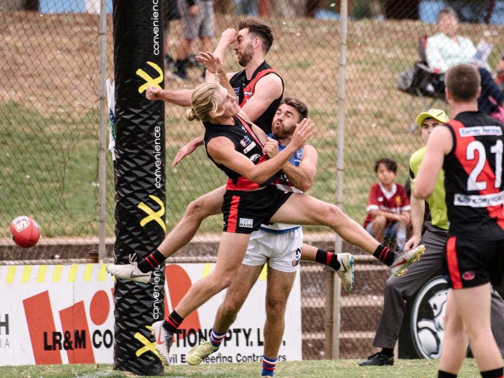 Elliot Dunkin Jonathon Beech and Isaya McKenzie are seen colliding as they go for the ball during the SANFL Central District versus West Adelaide match at Elizabeth Oval on Saturday April 13, 2019. (AAP Image/ Morgan Sette)