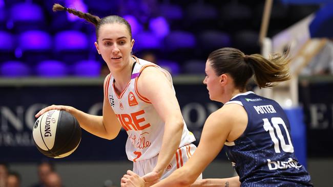 GEELONG, AUSTRALIA - OCTOBER 30: Courtney Woods of the Townsville Fire handles the ball against Gemma Potter of Geelong United during the round one WNBL match between Geelong United and Townsville Fire at The Geelong Arena, on October 30, 2024, in Geelong, Australia. (Photo by Kelly Defina/Getty Images)