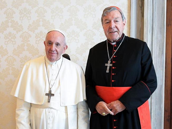 This handout photo taken on October 12, 2020, and released by the Vatican press office, the Vatican Media, shows Pope Francis (L) posing with Australian cardinal George Pell during a private audience at the Vatican. (Photo by Handout / VATICAN MEDIA / AFP)