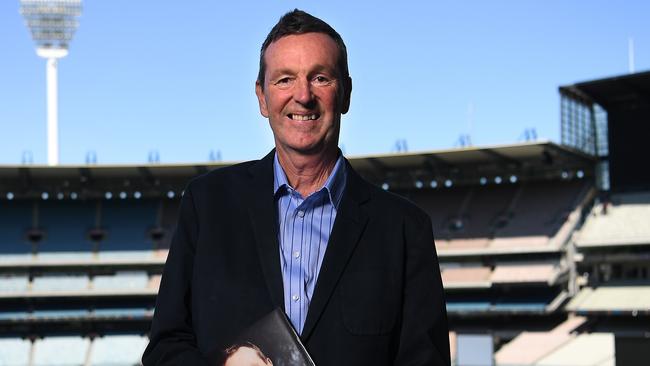 Former AFL player Neale Daniher poses for a photo with a copy of his book When All is Said & Done at the Melbourne Cricket Ground in Melbourne, Thursday, October 24, 2019. (AAP Image/Julian Smith) NO ARCHIVING