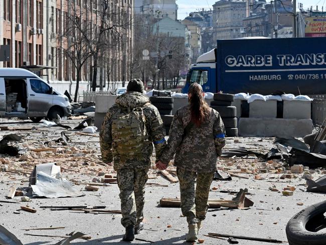 A couple of Ukrainian soldiers walks hand-in-hand amid the Russian invasion of Ukraine in Kyiv. Picture: AFP