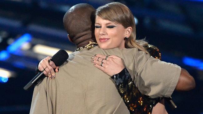 Kanye West accepts the Video Vanguard Award from recording artist Taylor Swift onstage during the 2015 MTV Video Music Awards.