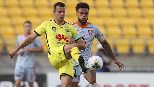 Steven Taylor of the Wellington Phoenix, left, and Aaron Amadi-Holloway of the Brisbane Roar during the round-seven A-League match at Westpac Stadium in Wellington on Saturday. Picture: AAP