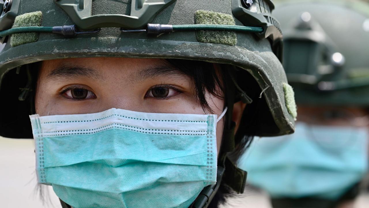 Female soldiers wearing face masks amid the COVID-19 coronavirus pandemic stand in formation in Taiwan. Picture: Sam Yeh / AFP