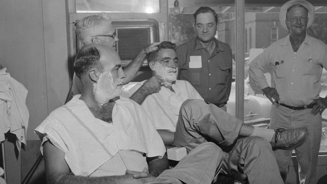 John W. Milam (seated left) relaxes while barber J.J. Taylor lathers the face of Roy Bryant. The shave came just before the half brothers were arraigned in Sumner, Mississippi in 1955, on charges they kidnapped and murdered Till.