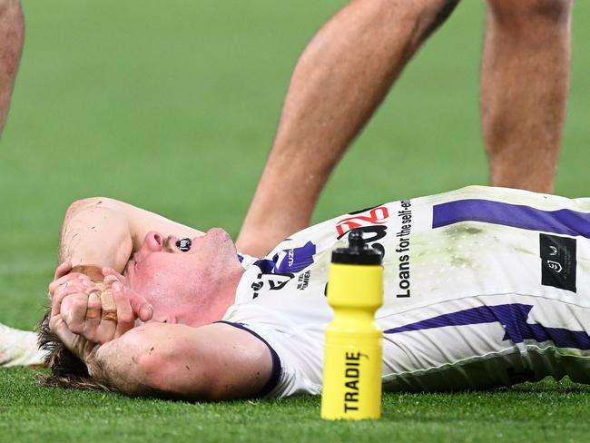 BRISBANE, AUSTRALIA - SEPTEMBER 08:  Ryan Papenhuyzen of the Storm is attended to by a team trainer after an ankle injury during the NRL Qualifying Final match between the Brisbane Broncos and Melbourne Storm at Suncorp Stadium on September 08, 2023 in Brisbane, Australia. (Photo by Bradley Kanaris/Getty Images)