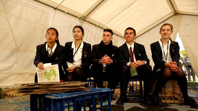 St Mark's Catholic College students Aliyah Dera 15, Tori Williams 15, Tye Dunnastill 16, Connor Godwin 15, and Emily Rozanc 15 sit in a classroom in the refuge camp in Auburn. St Mark's Catholic College students were taking part in the Refuge camp in my Neighbourhood program. (AAP IMAGE/ Justin Sanson)