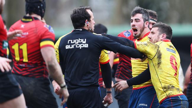 Romanian referee Vlad Lordachescu is pushed by Spanish players after their defeat to Belgium during their Rugby World Cup qualifier at Little Heysel in Brussels.