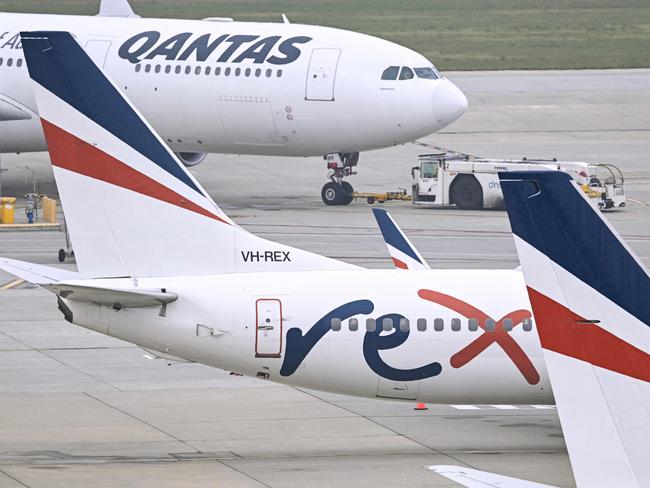 Rex Airlines Boeing 737 planes lay idle on the tarmac at Melbourne's Tullamarine Airport on July 31, 2024. The Australian regional airline Rex cancelled flights as it entered voluntary administration on July 31, leaving the fate of the country's third-largest carrier in serious doubt. (Photo by William WEST / AFP)