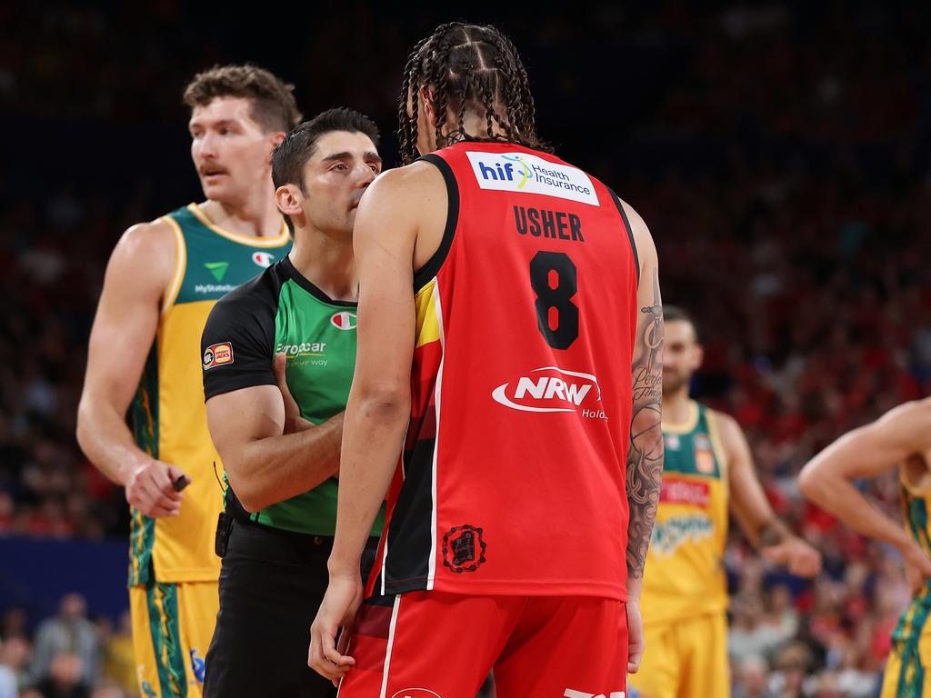 Referee Nicolas Fernandes talks with Jordan Usher during the fiery match-up. Picture: Getty