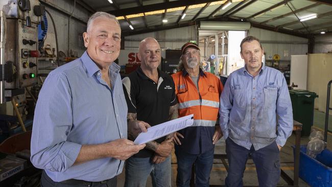 David Bruce (far left) with Maurice Dry Cleaning owner Chrys Press, Chris Birch from CBCH/Max Crane, Whyalla Hose and Fitting Services general manager Jarrod Starkey and the paperwork from the government showing a 50 per cent payment of invoices will be made. Picture: Brett Hartwig