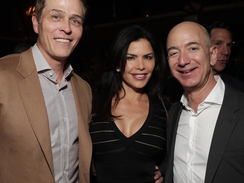 Patrick Whitesell, Lauren Sanchez and Amazon CEO Jeff Bezos. Bezos’s affair with Sanchez was exposed by the National Enquirer. Picture: Getty Images/Amazon Studios