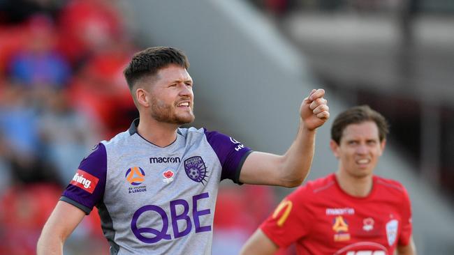 Perth Glory’s Alex Grant and Adelaide United’s Craig Goodwin during Reds 2-0 loss at Coopers Stadium on Sunday (AAP Image/David Mariuz)