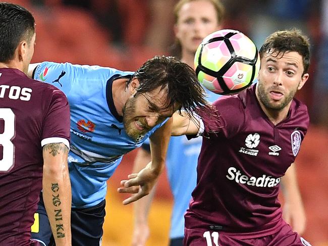 Joshua Brillante of Sydney FC (centre) heads the ball during their Round 18 A-League game against Brisbane Roar at Suncorp Stadium in Brisbane, Friday, Feb. 3, 2017.(AAP Image/Dan Peled) NO ARCHIVING, EDITORIAL USE ONLY