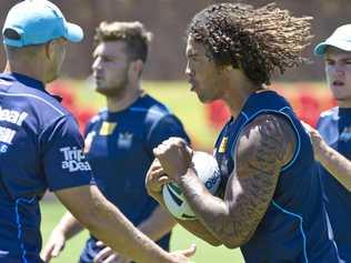 WORKING HARD: Kevin Proctor takes on the line during the Gold Coast Titans open training session at Clive Berghofer Stadium last year. The Titans will face the St George Illawarra Dragons at Clive Berghofer Stadium this Sunday. Picture: Kevin Farmer