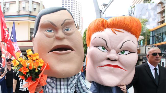 Protestors dressed as caricatures of Queensland Opposition Leader Tim Nicholls (centre) and One Nation Leader Senator Pauline Hanson are seen as union protestors from the Queensland Council of Unions (QCU) march through the Brisbane CBD in Brisbane, Wednesday, November 22, 2017. (AAP Image/Jono Searle) NO ARCHIVING