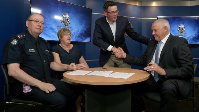 Police Chief Commissioner Graham Ashton, Minister for Police Lisa Neville, Premier Daniel Andrews and Police Association secretary Ron Iddles sign the contracts. Picture: Hamish Blair