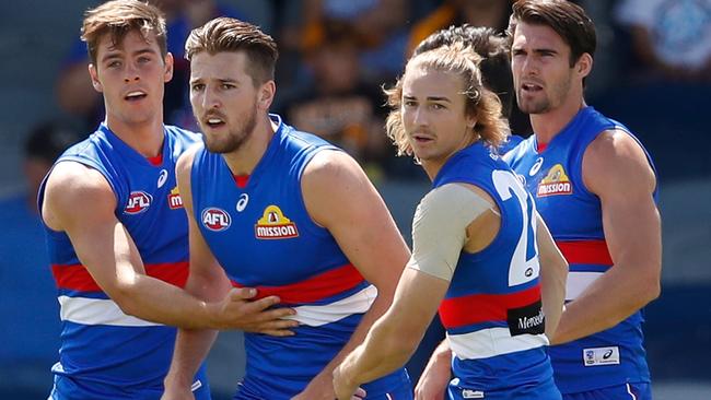 Marcus Bontempelli (second from left) led the Bulldogs to victory in their JLT match against Hawthorn. Picture: Getty Images