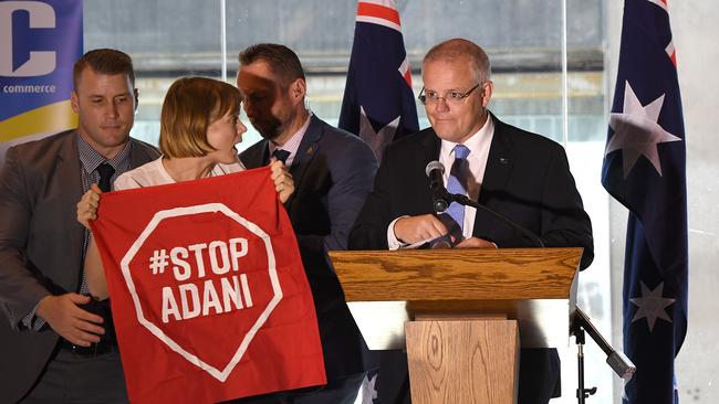 A Stop Adani protester is removed from the stage during Australian Prime Minister Scott Morrison’s speech at the Valley Chamber of Commerce business luncheon in Brisbane earlier this month. Picture: AAP/Dave Hunt