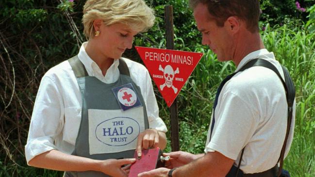 Princess Diana uses a remote switch to trigger the detonation of some explosive ordinance dug up by mine sweepers in Huambo.