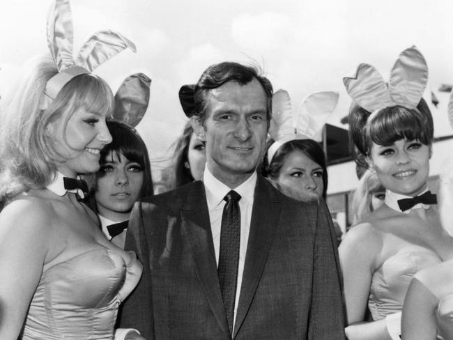 Hefner is greeted by bunny girls from his Playboy Clubs, upon his arrival at London Airport. Pic: Dove/Getty Images.