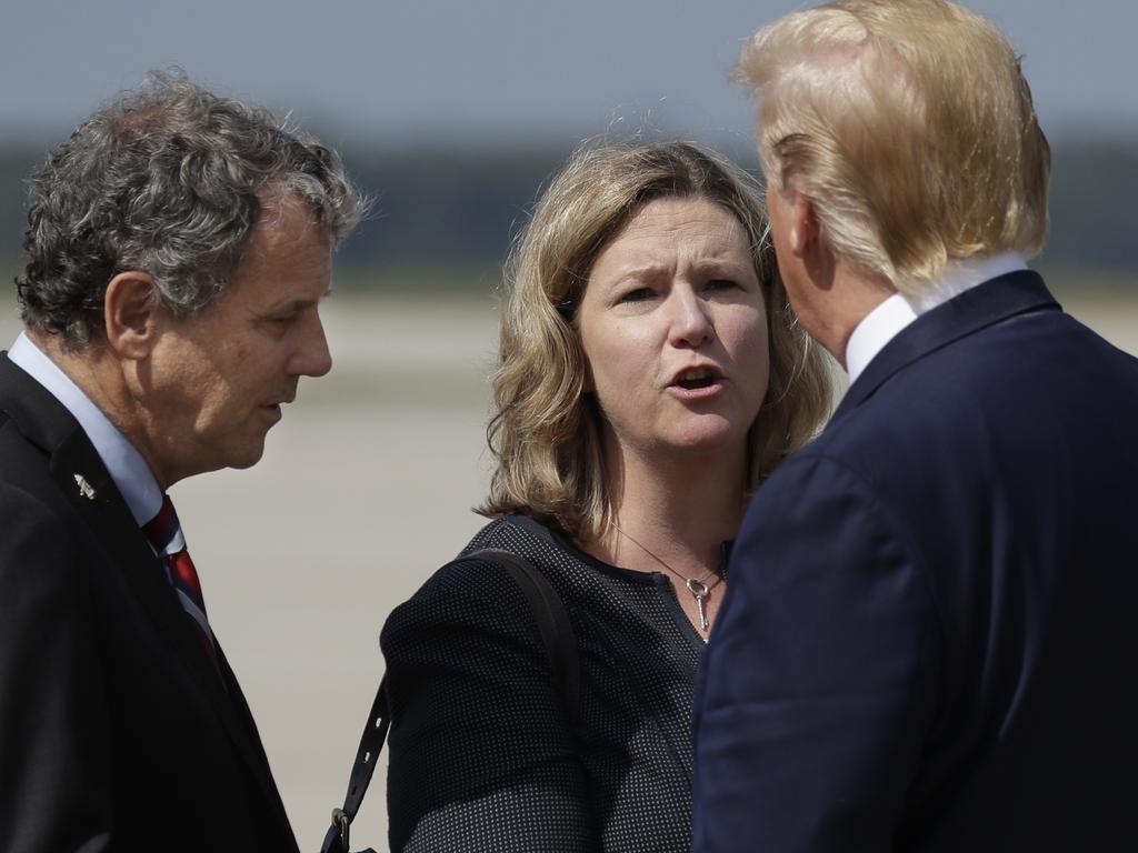 President Donald Trump is greeted by Dayton Mayor Nan Whaley and Democrat Senator Sherrod Brown after arriving at Wright-Patterson Air Force Base in Dayton. Picture: AP