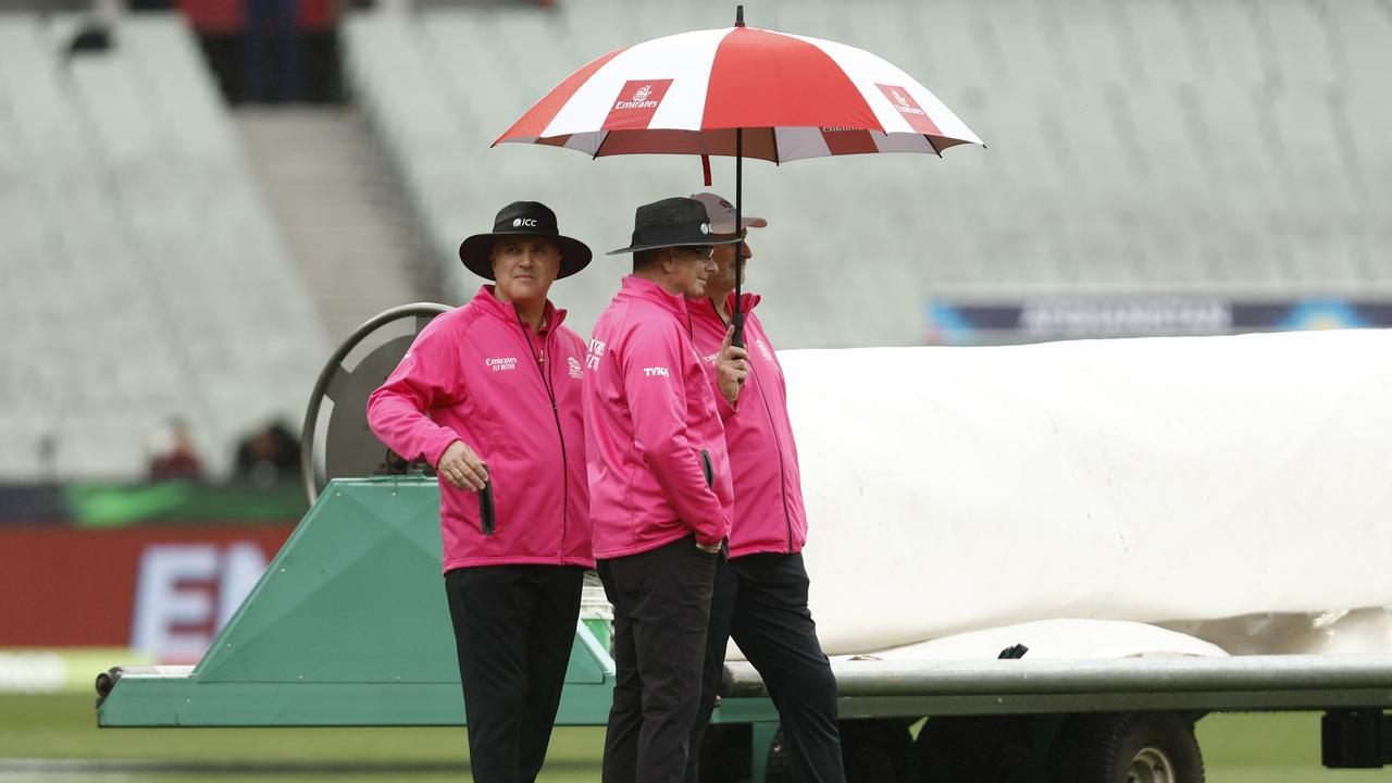 MELBOURNE, AUSTRALIA - OCTOBER 26: Umpires wait for rain to clear before the ICC Men's T20 World Cup match between England and Ireland at Melbourne Cricket Ground on October 26, 2022 in Melbourne, Australia. (Photo by Darrian Traynor/Getty Images)