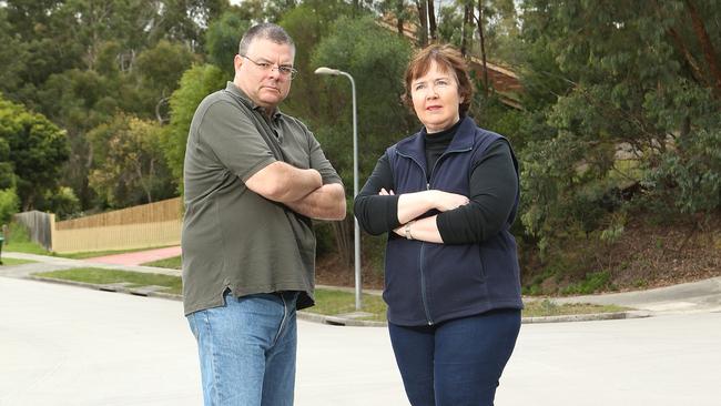 Deep Creek Drive residents Clarke Stevenson and Leanne White are unhappy with the white resurfacing of their street, which cost $178,000. Picture: Hamish Blair