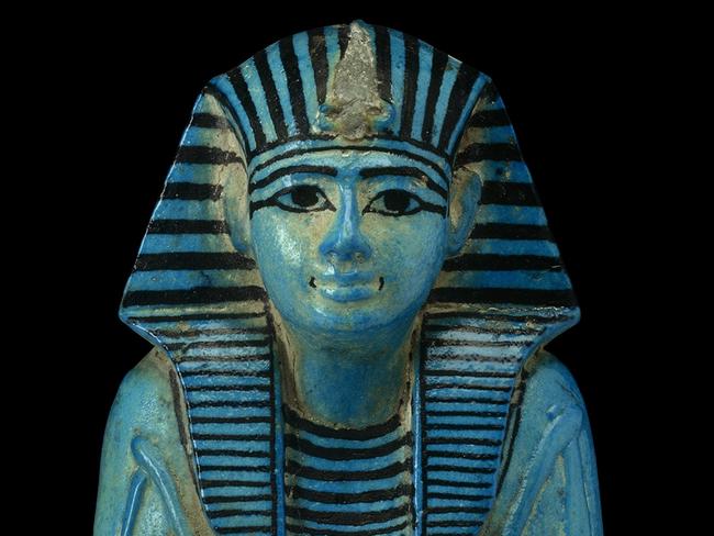 Only to be used in relation to NGV exhibition, Pharaoh (2024): Shabti of Pharaoh Sety I. From Tomb of Sety I, Valley of the Kings, Thebes, Egypt. 19th Dynasty, reign of Sety I, about 1294-1279 BC. Blue faience, H 22.8 cm, W 9.6 cm, D 9.6 cm © The Trustees of the British Museum