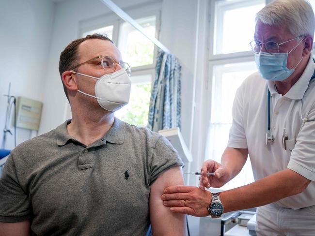 German Health Minister Jens Spahn (L) gets an influenza vaccination at the doctor's surgery in Berlin. Picture: AFP