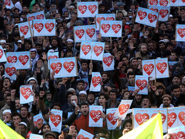 Afghans hold posters that read ‘I love Muhammad’ during a protest against Charlie Hebdo’s satirical caricatures. Picture: Rahmat Gul