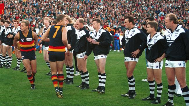 Geelong players including Bill Brownless (right) form a guard of honour for Adelaide before a game against the Crows in 1994.