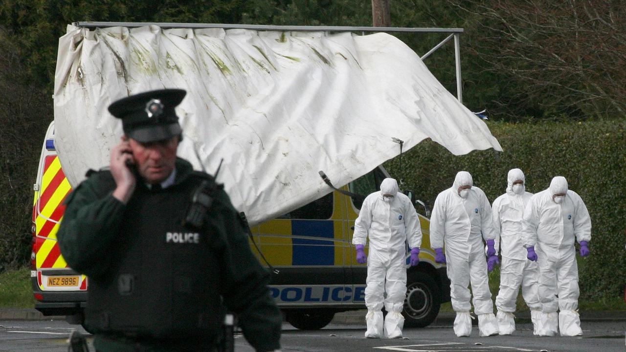 Forensic officers examine the scene at the Massereene army barracks in Antrim, Northern Ireland in 2009 after two British soldiers were shot dead and four people wounded in a drive-by ambush blamed on IRA dissidents.