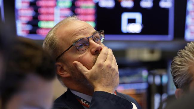 A Wall Street trader reacts as stocks fall again on Friday night.