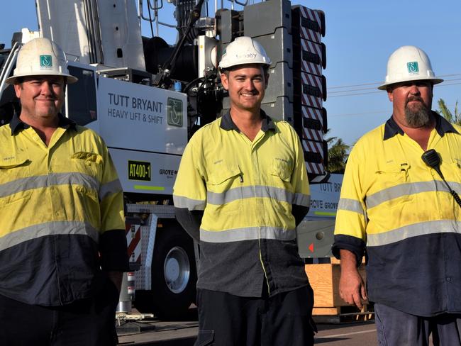 Tutt Bryant crane operators Heath Lowman, Michael Woods and Alex Wilson stand in front of the Territory's tallest crane. Picture: Sierra Haigh