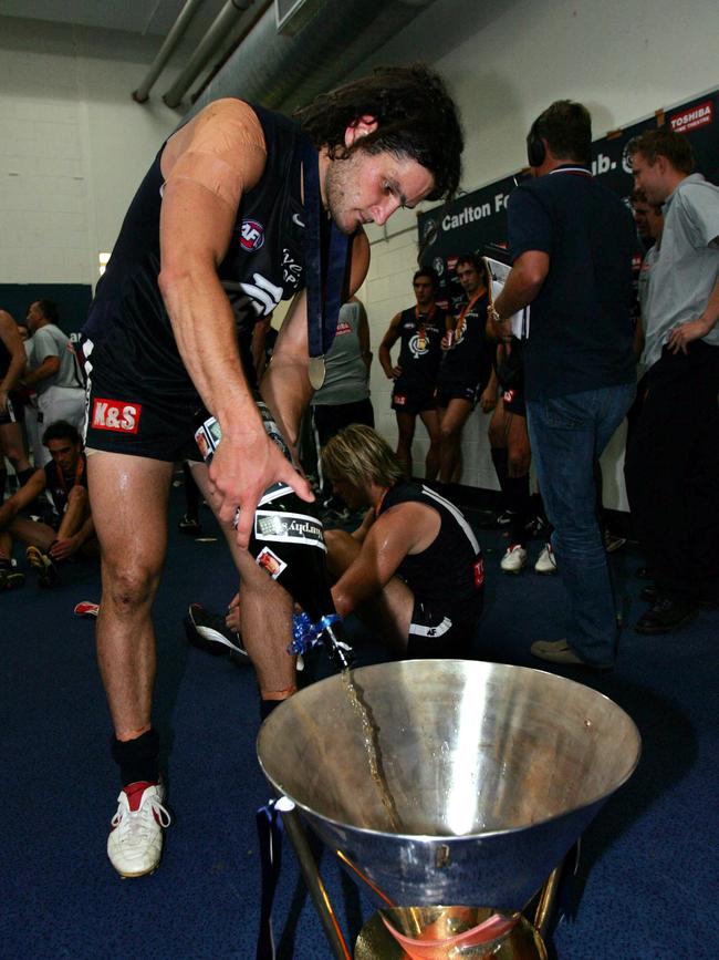 Fevola pours champagne into the Wizard Cup.