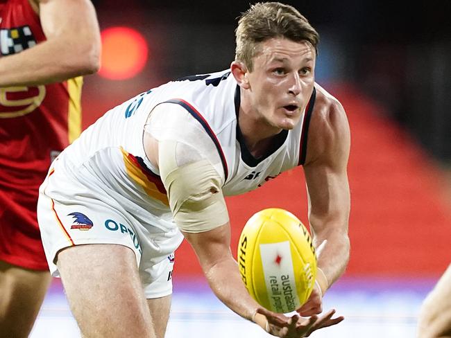 Matt Crouch of the Crows hand-balls during the Round 3 AFL match between the Gold Coast Suns and the Adelaide Crows at Metricon Stadium on the Gold Coast, Sunday, June 21, 2020. (AAP Image/Dave Hunt) NO ARCHIVING, EDITORIAL USE ONLY