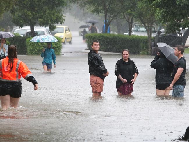 Residents in the flood waters of Bowen st, Windsor on February 27. Picture: Anthony Reginato